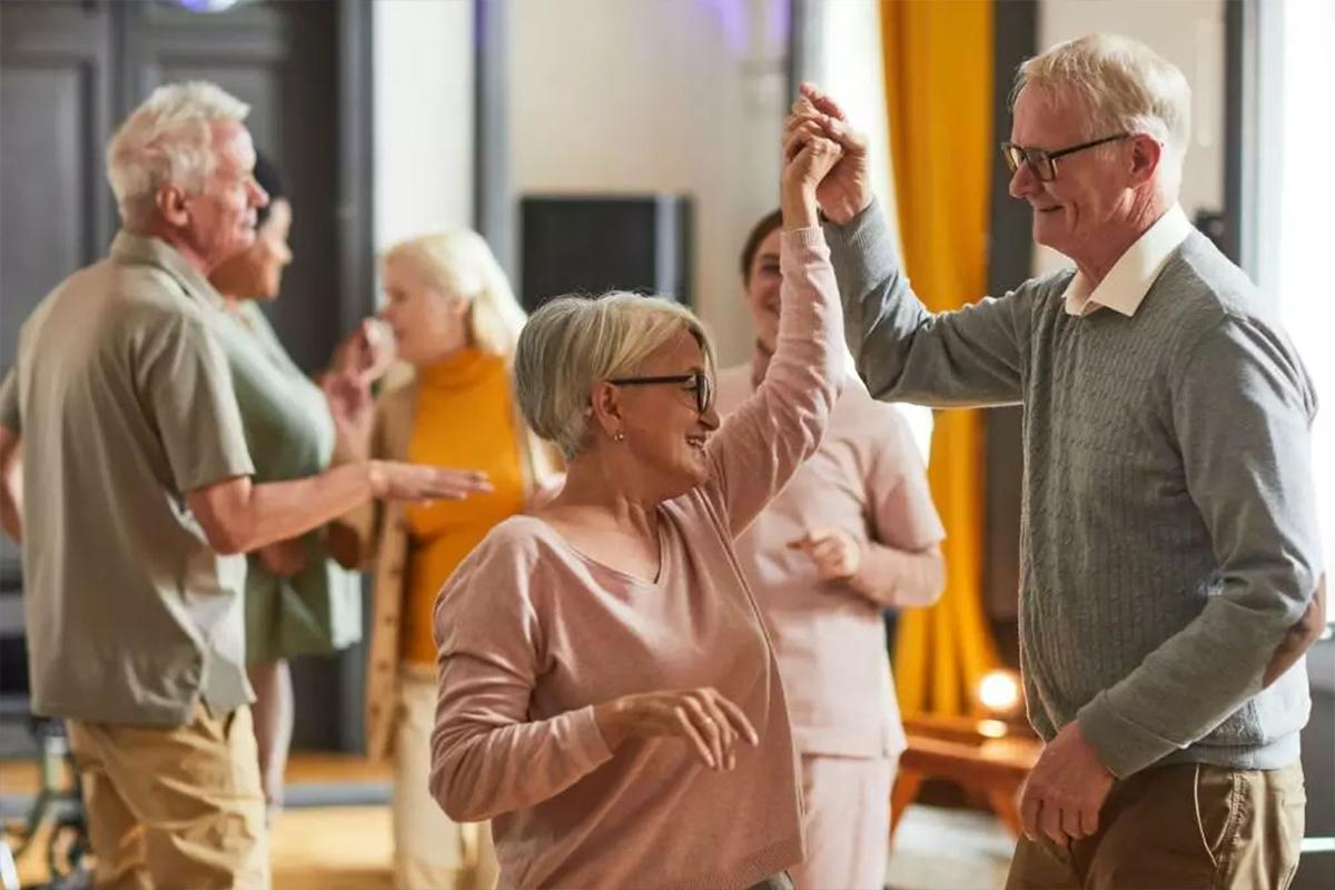 Photo of smiling people dancing together