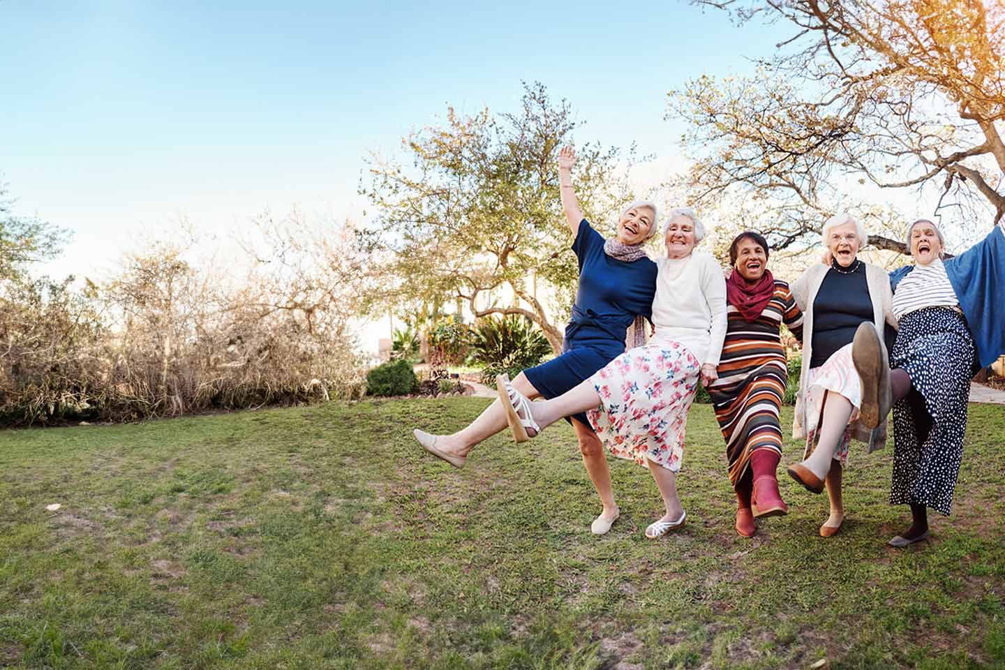 Photo of women dancing together in a park