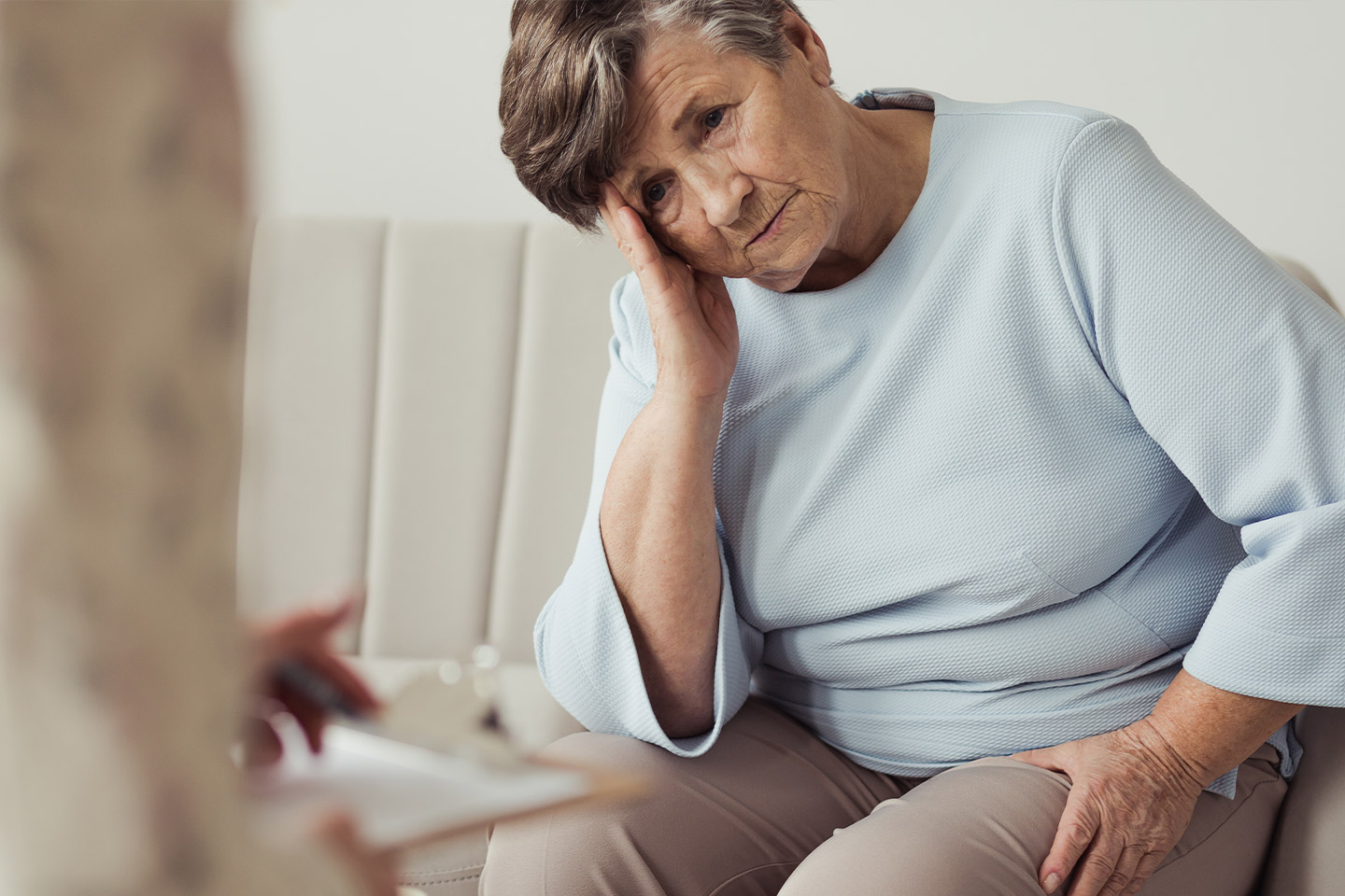 Photo of seated woman with her head on her hand
