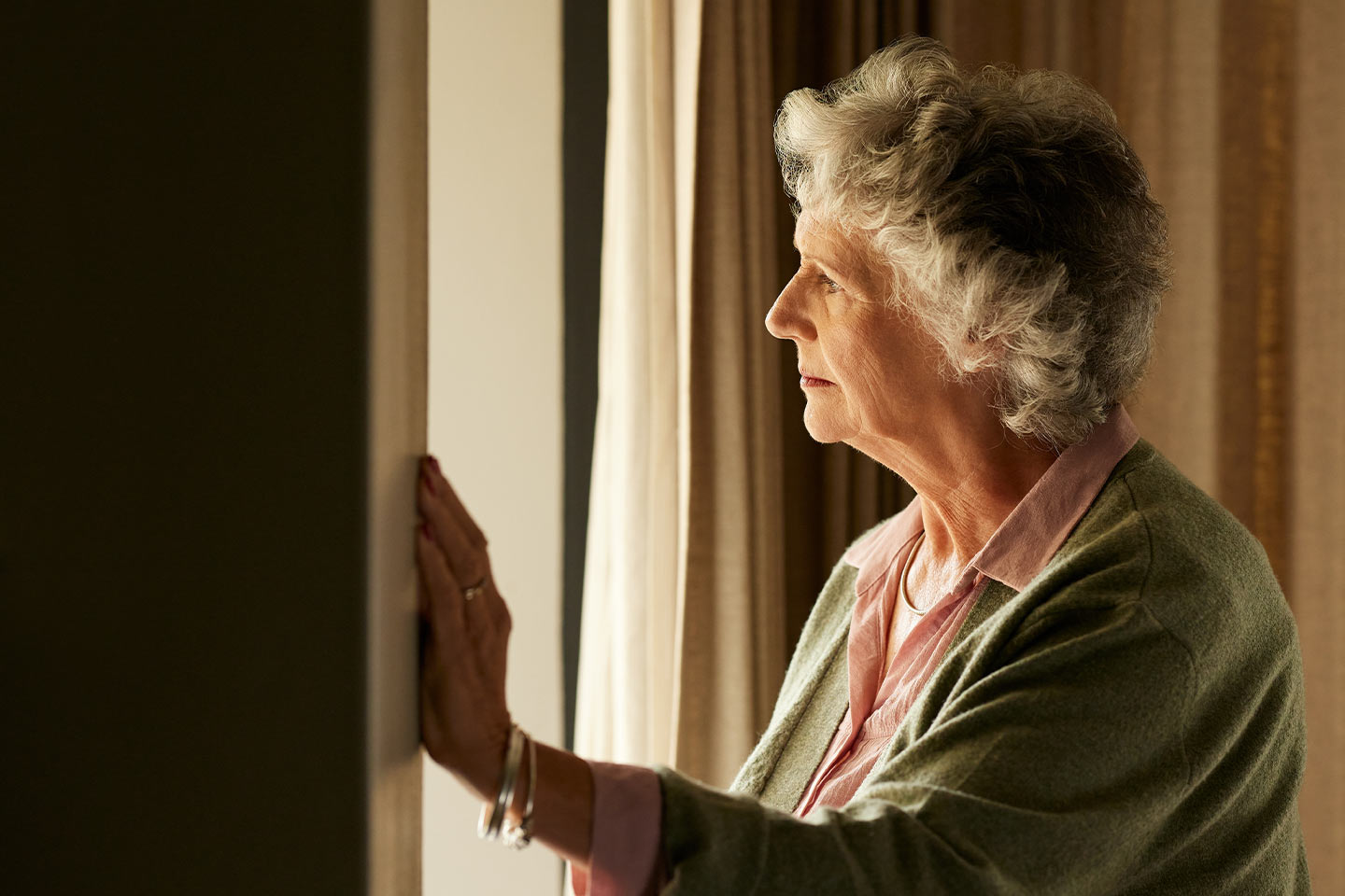 Photo of woman looking through a window