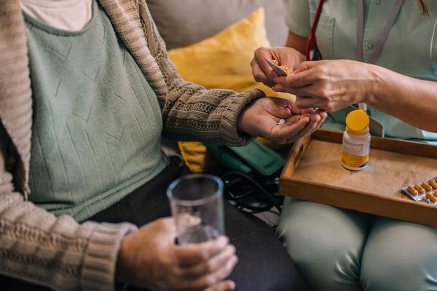 Photo of hands dispensing medicine to someone