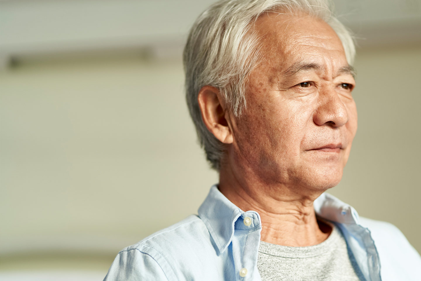 Photo of a man with white hair facing the sunlight