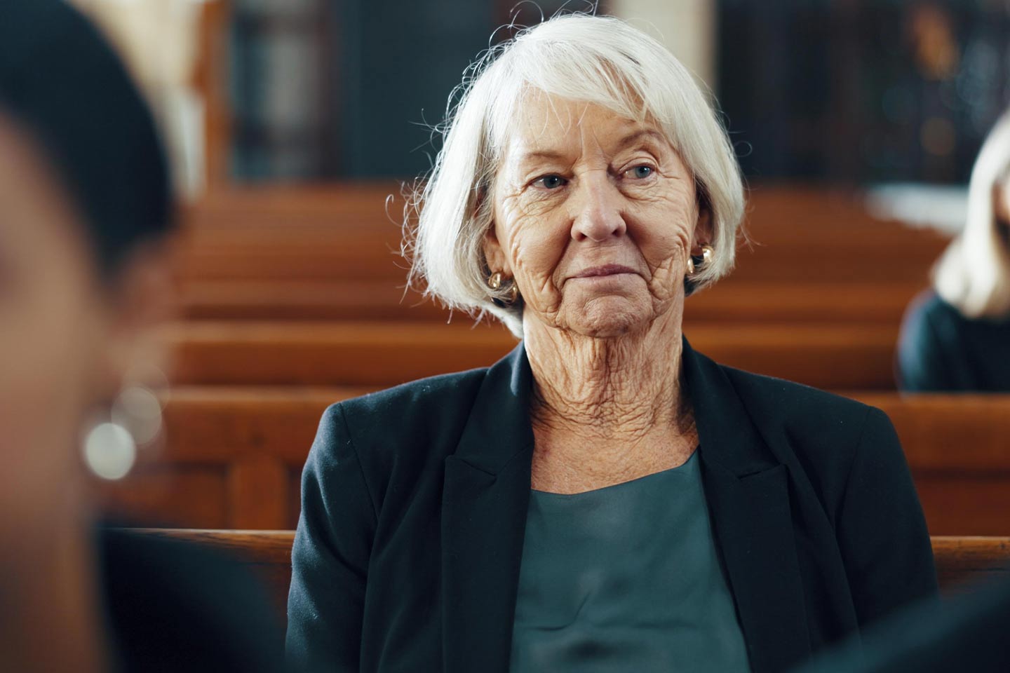 Photo of woman sitting in a pew