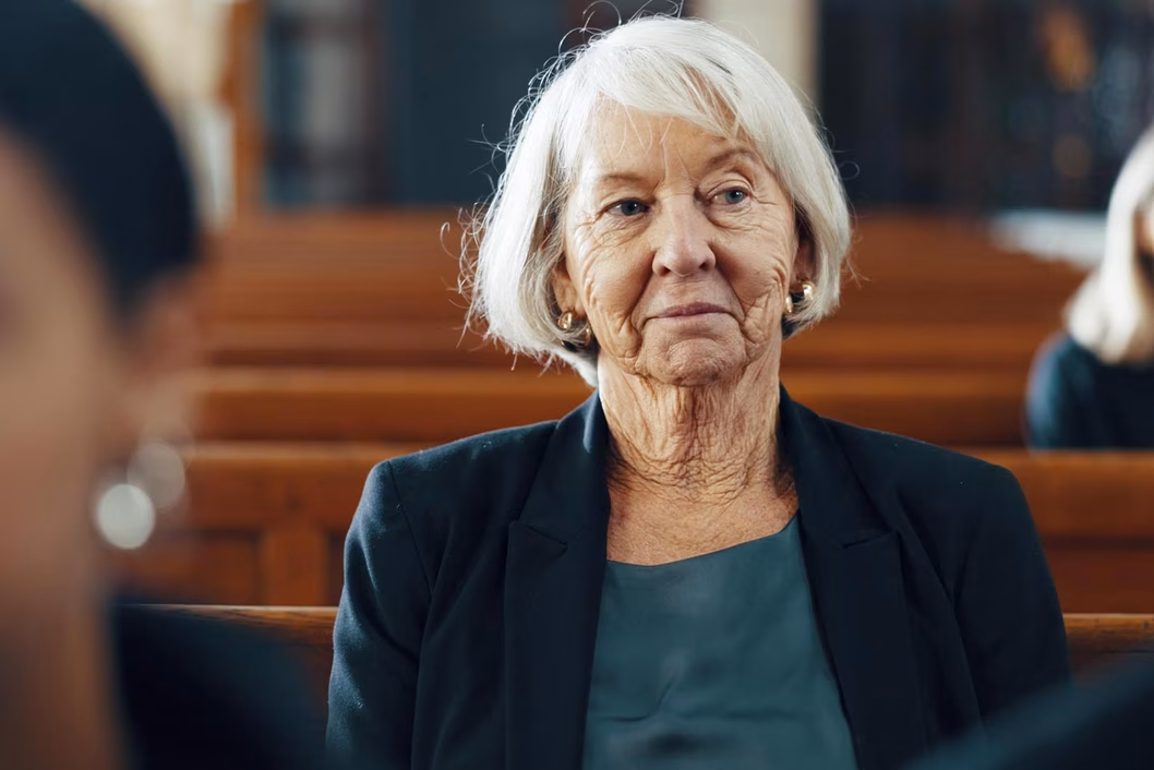 Photo of woman sitting in a pew