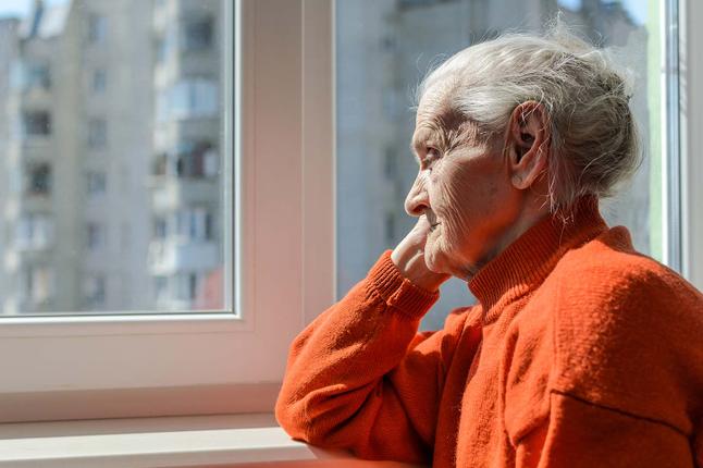 Photo of a senior lady in an orange jumper