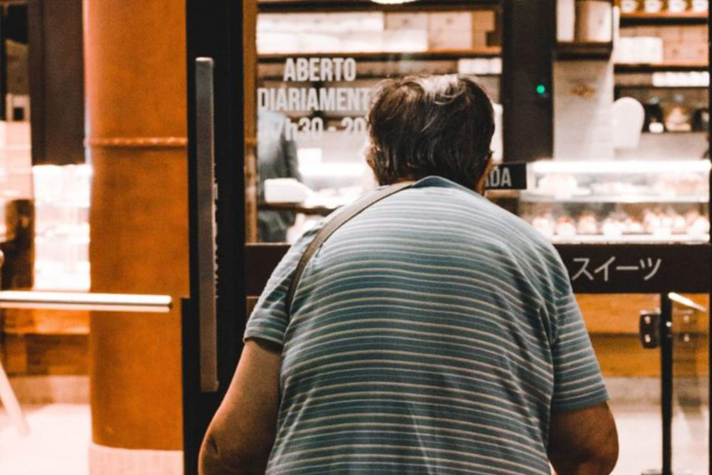 Photo of a stooped person entering a shop
