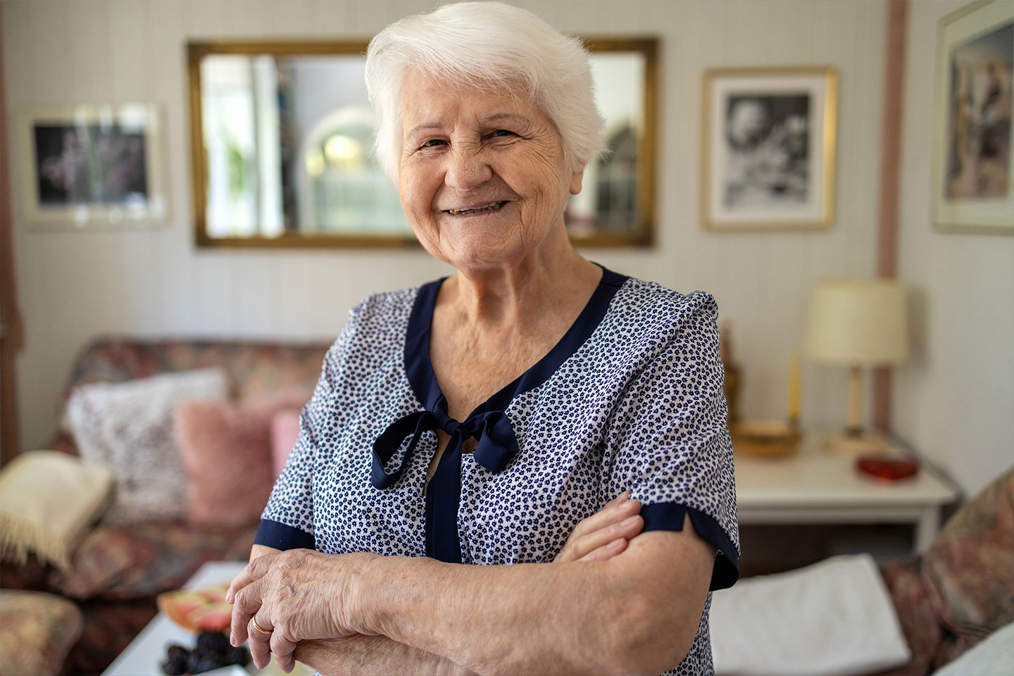 Photo of smiling woman in a navy spotted dress