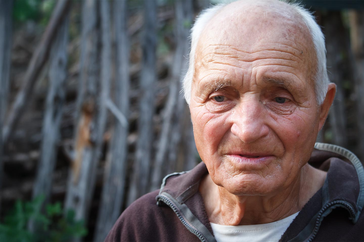 Photo of a sad looking man in a brown jumper