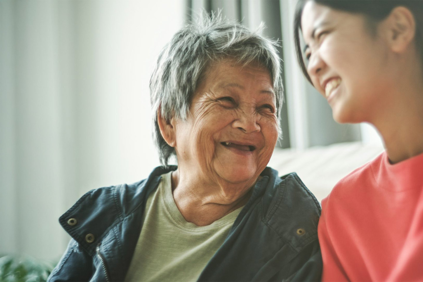 Photo of two women laughing together