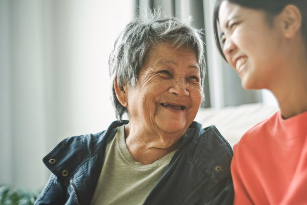 Photo of two women laughing together