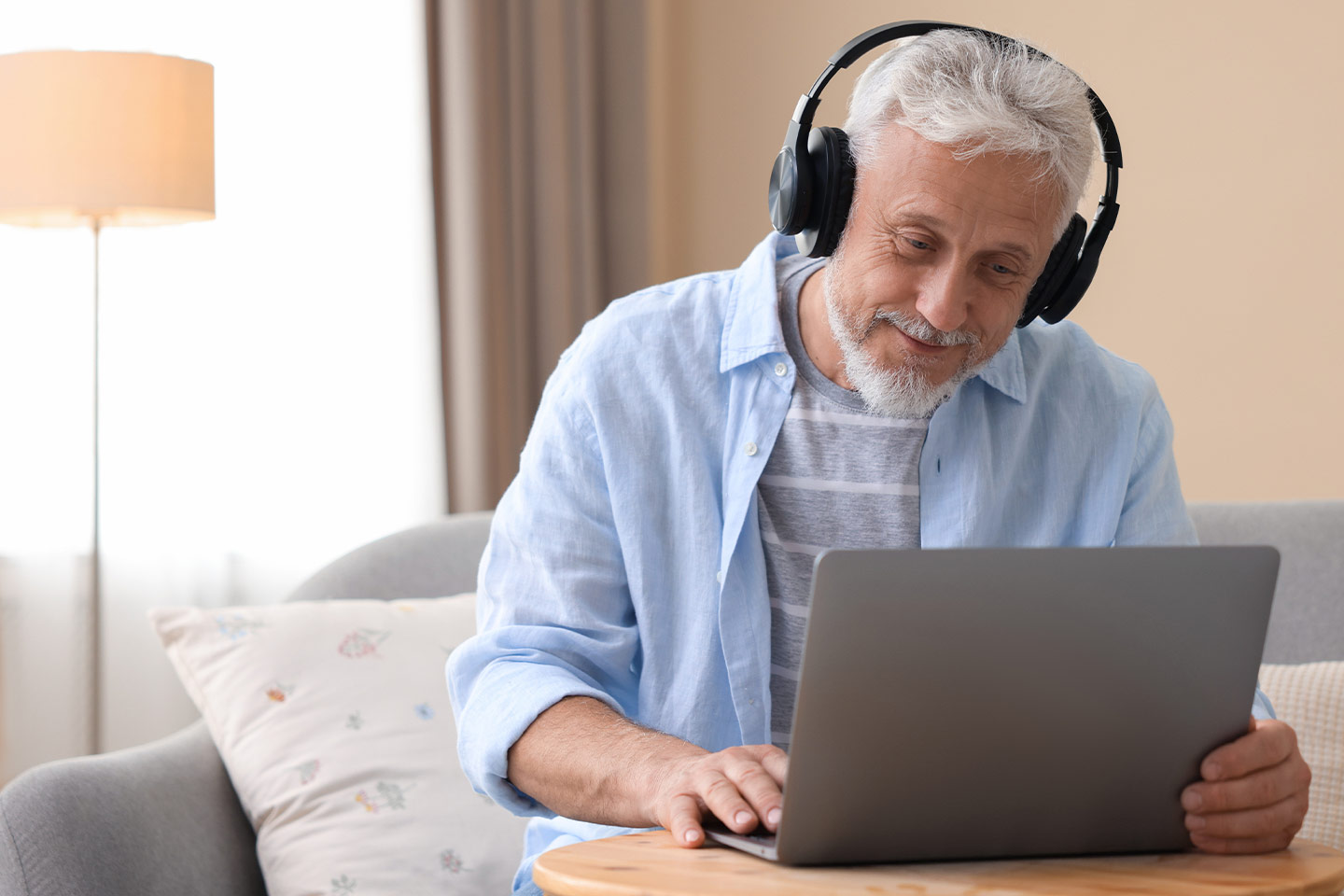 Photo of a smiling man wearing headphones
