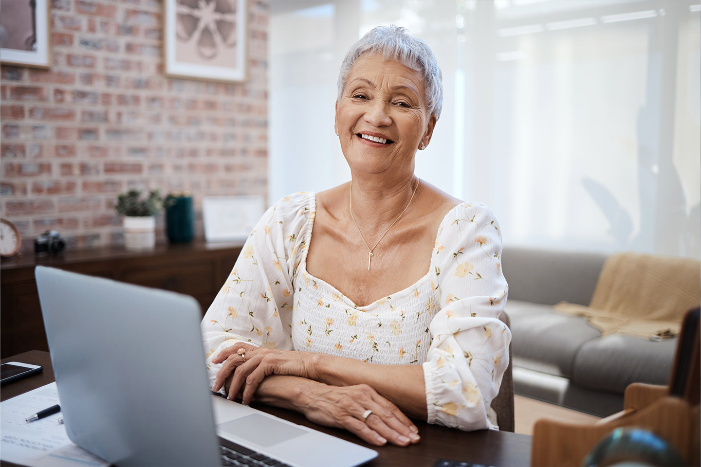 Photo of smiling woman sitting with a laptop