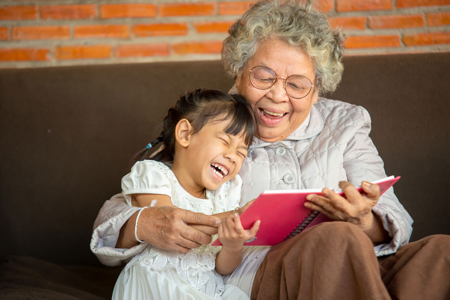 Grandmother and granddaughter reading together