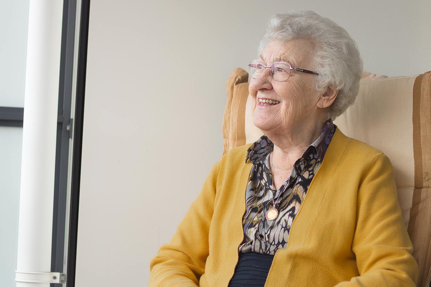 Photo of a woman in a mustard cardigan