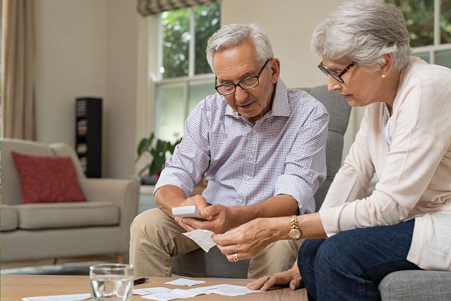 Photo of couple looking at receipts together