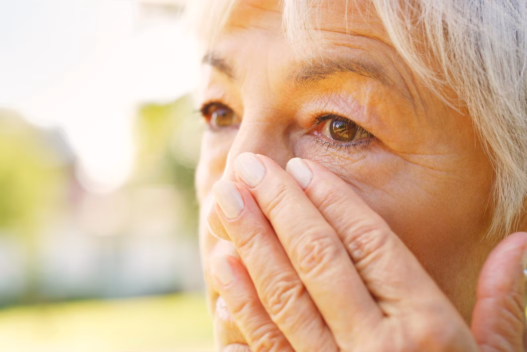 Photo of woman wiping away tear