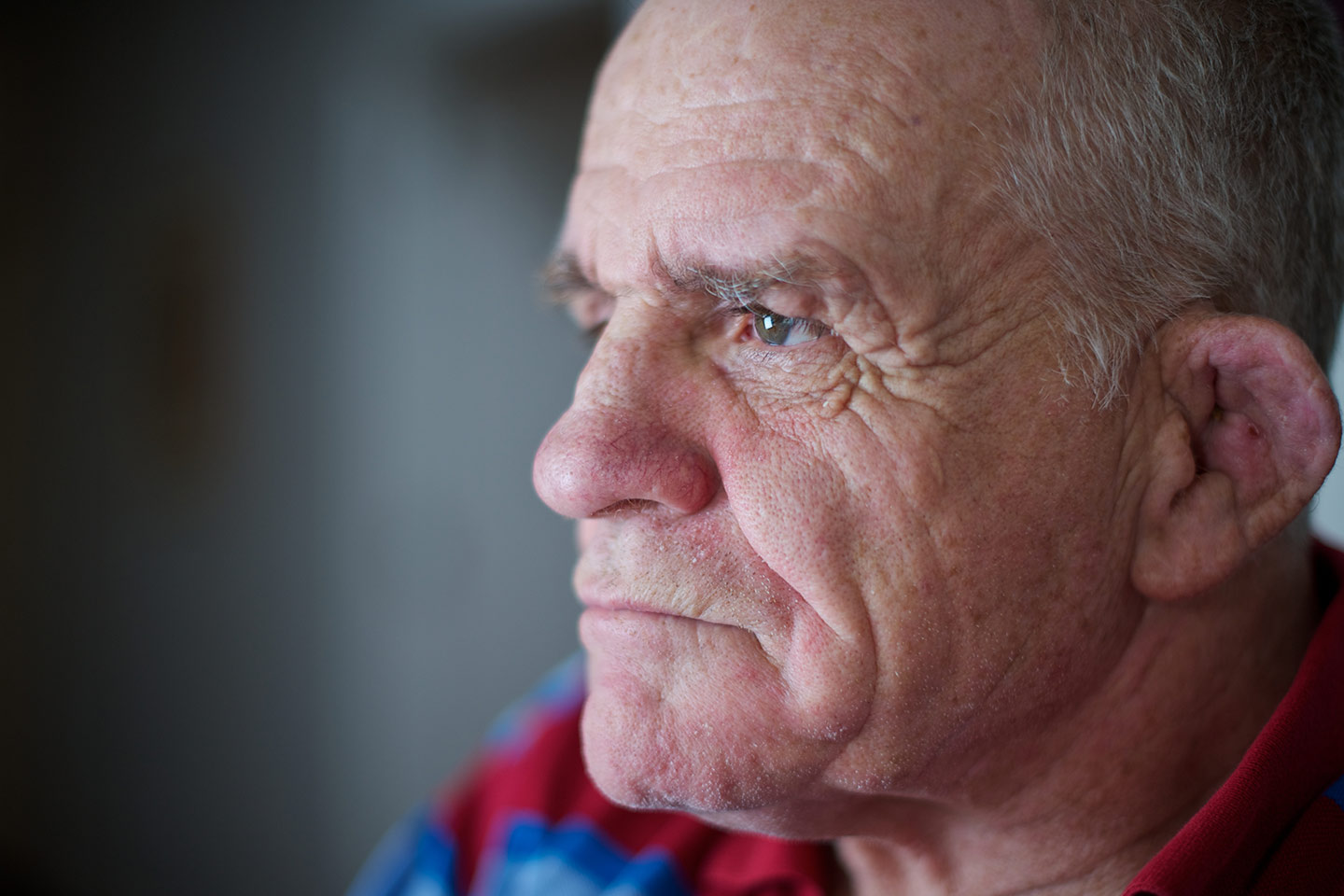 Photo of a man looking intensely towards a light source