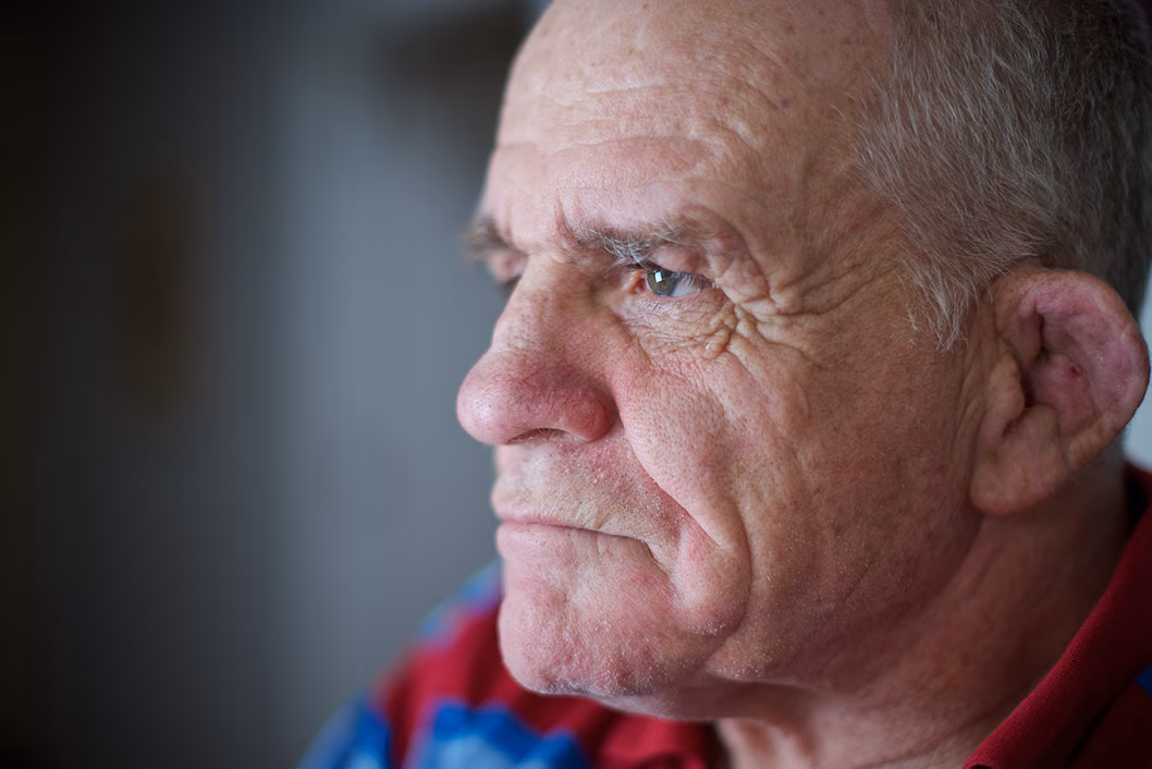 Photo of a man looking intensely towards a light source