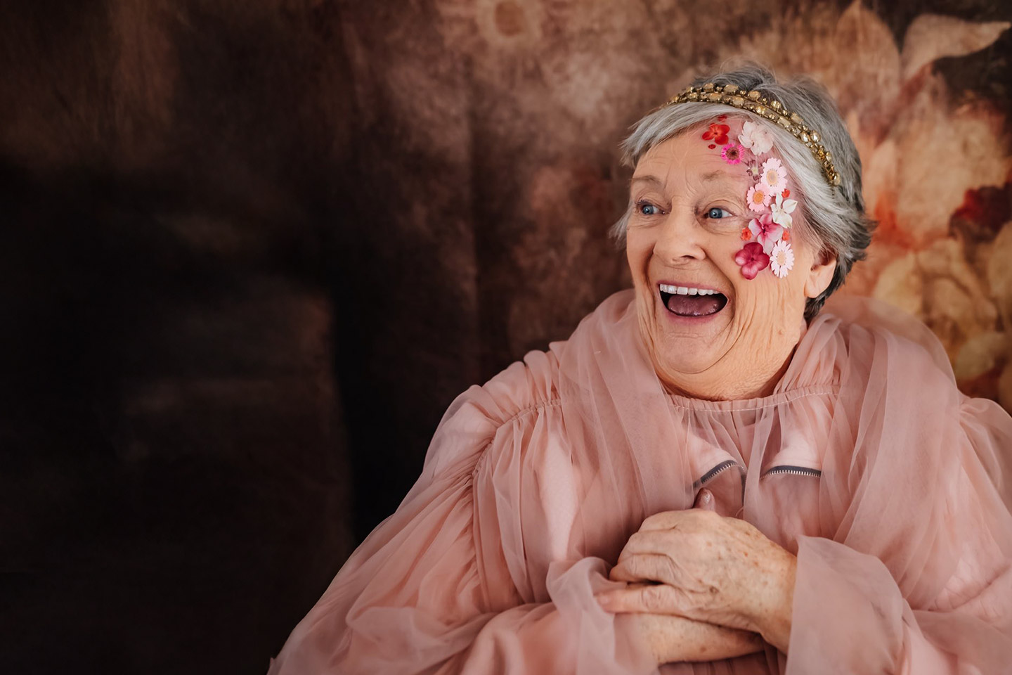 Photo of a woman wearing dusty rose organza and flowers