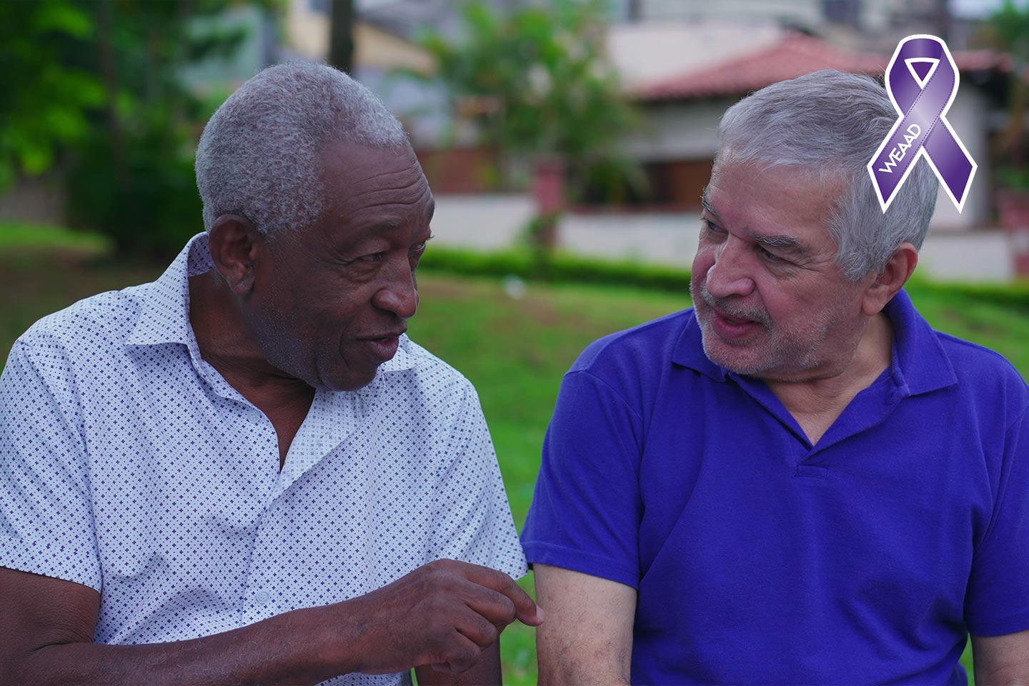 Photo of two men chatting outdoors