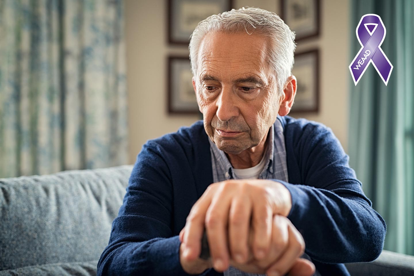 Photo of a man sitting in a aqua toned lounge area