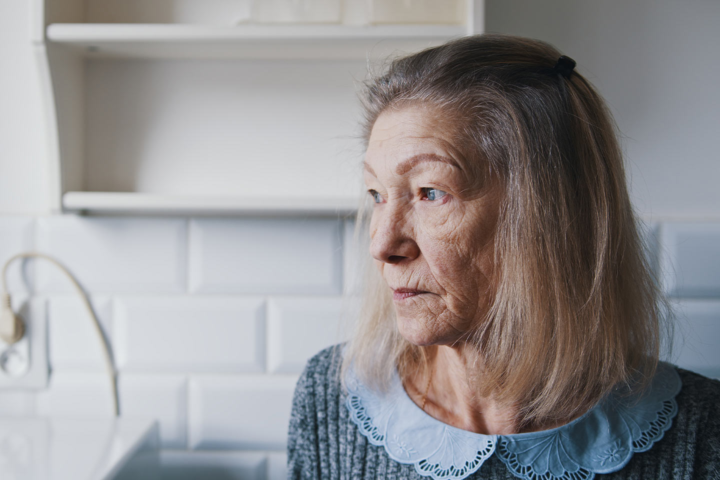 Photo of woman in a white room wearing pale blue