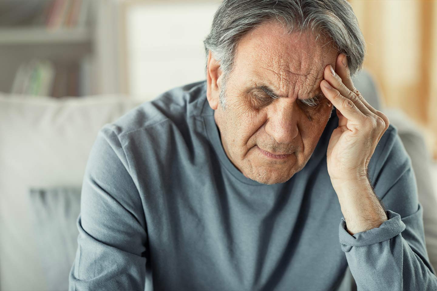 Photo of a man with his hand to his head