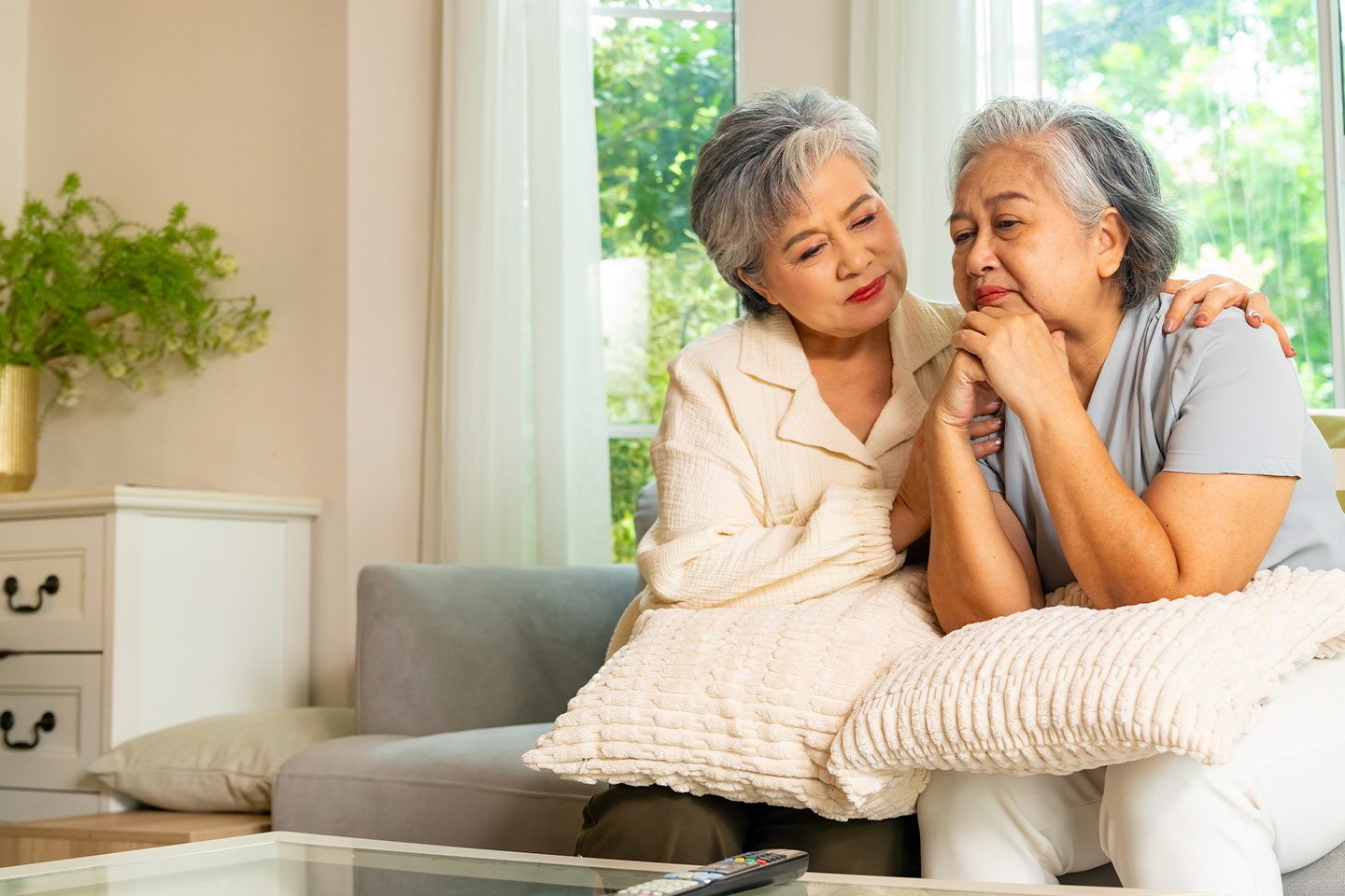 Photo of one woman comforting another