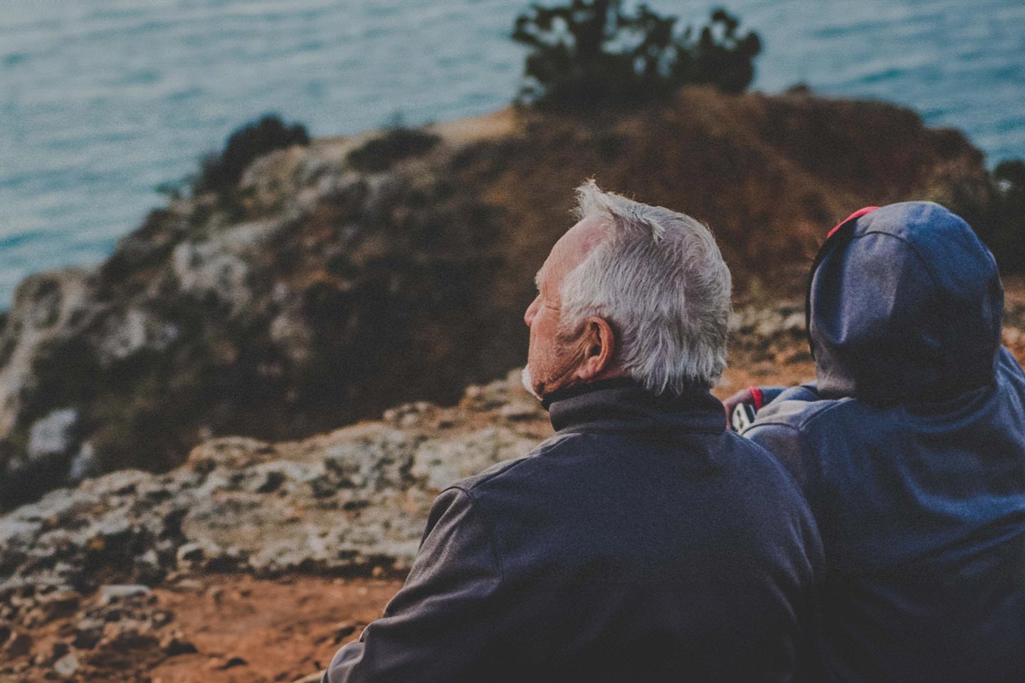 Photo of older couple on a rocky outcrop