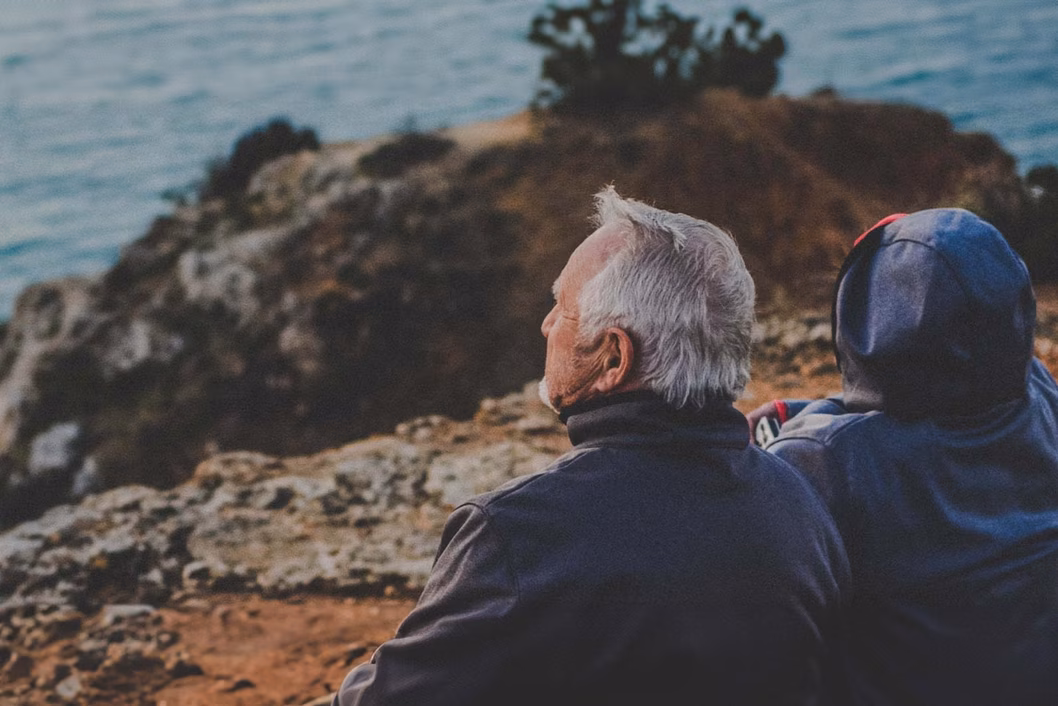 Photo of older couple on a rocky outcrop