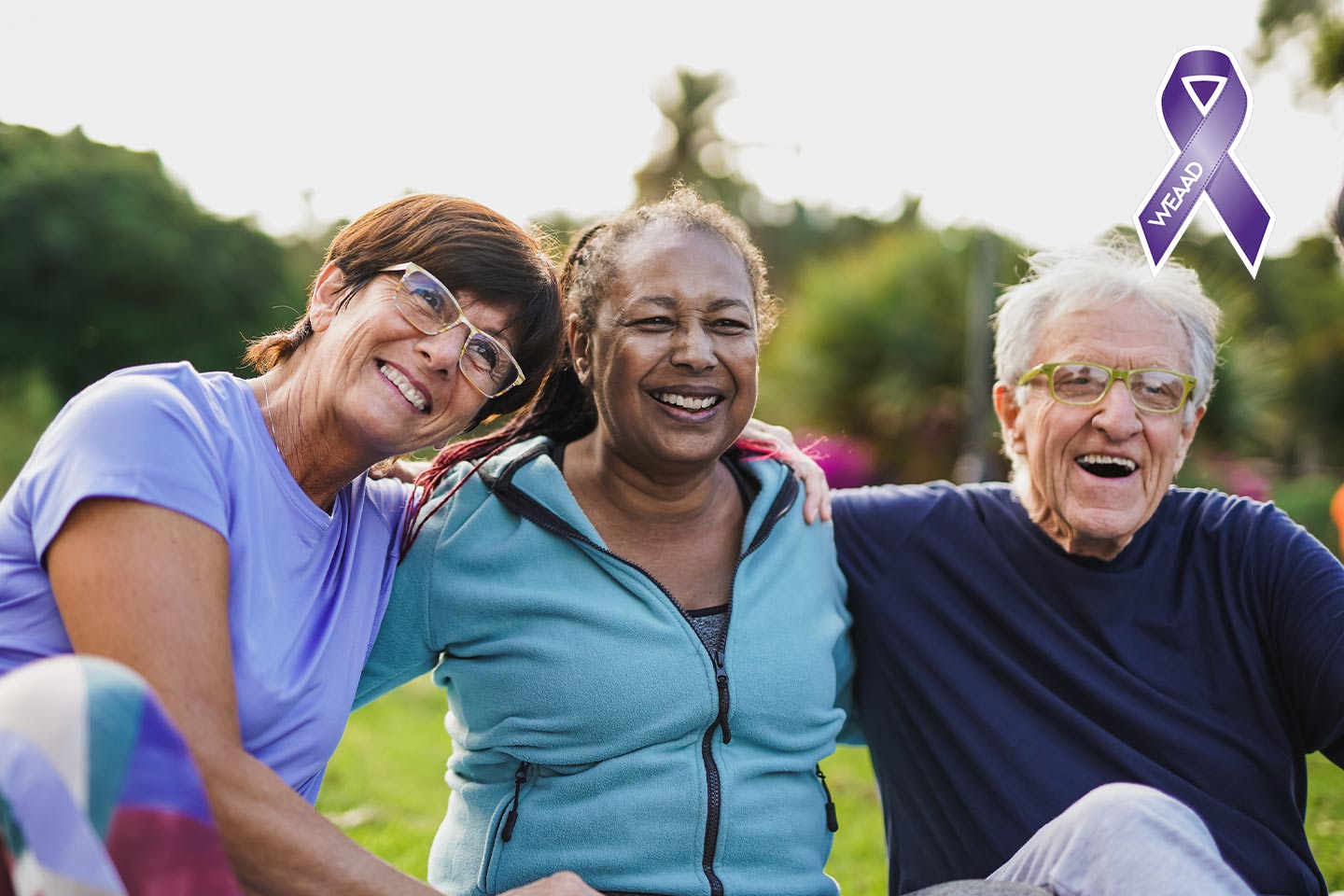 Photo of three friends laughing in a park
