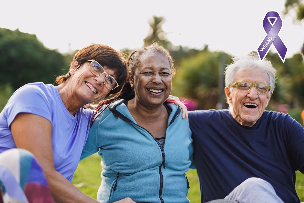 Photo of three friends laughing in a park