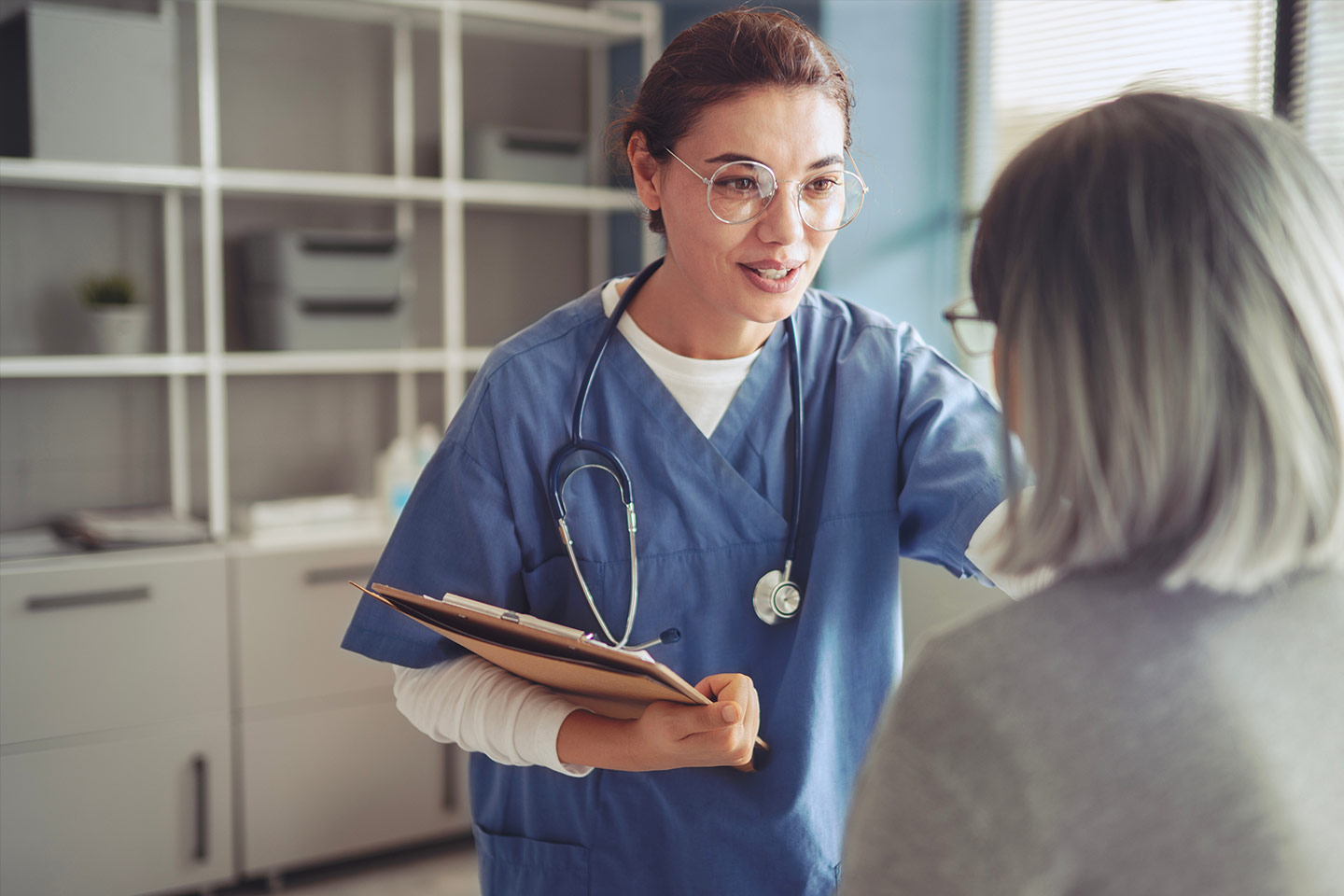 Photo of a health worker with a stethoscope and clipboard