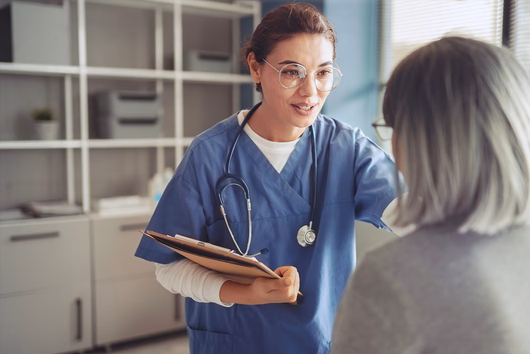 Photo of a health worker with a stethoscope and clipboard