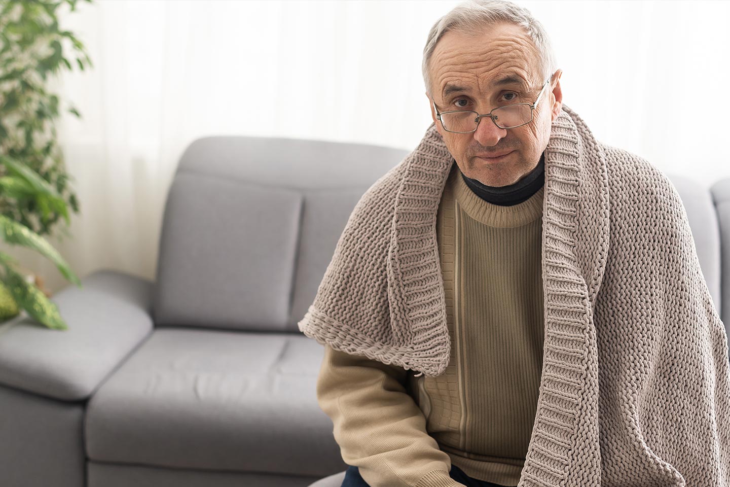 Photo of a man wearing a beige knit shawl