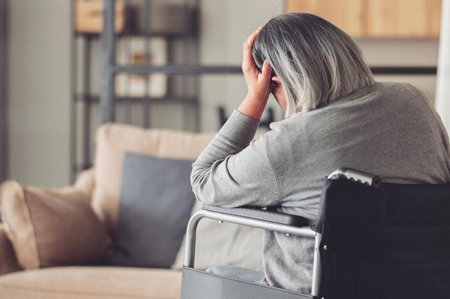 Photo of a person in a wheelchair with her back to us