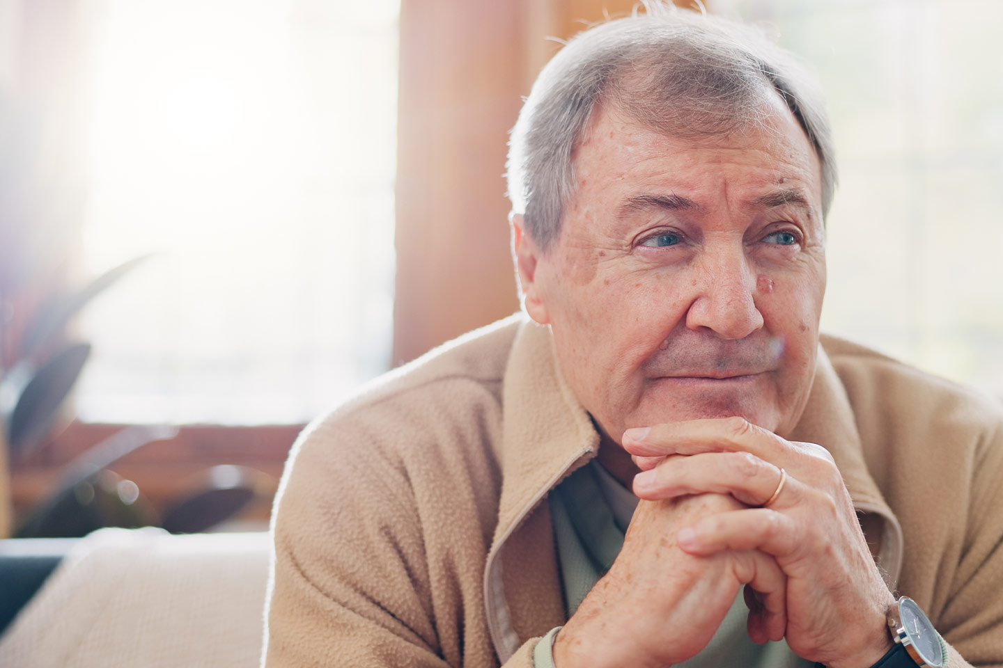 Photo of a man in a beige polar fleece jacket