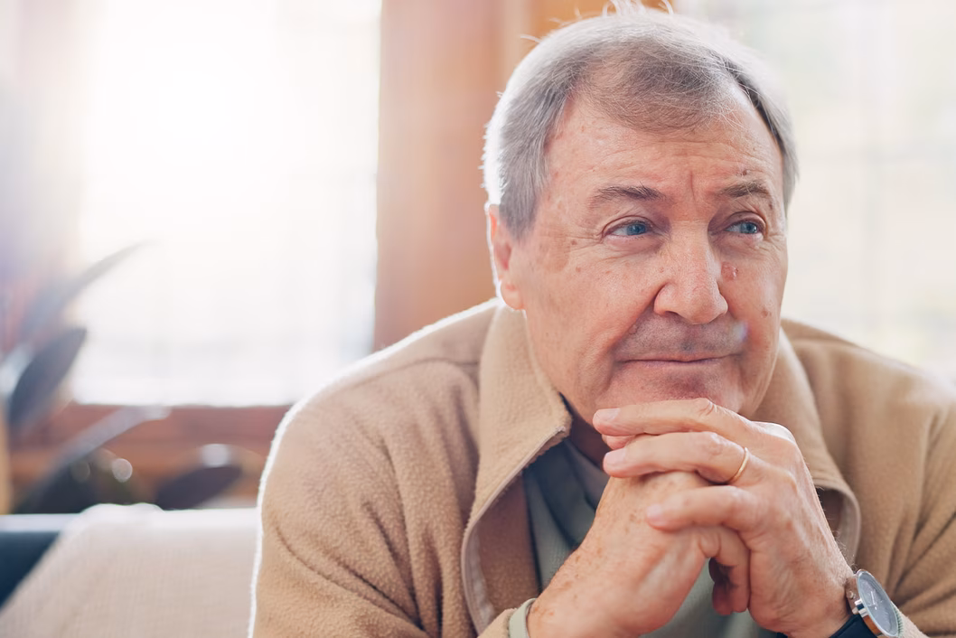 Photo of a man in a beige polar fleece jacket