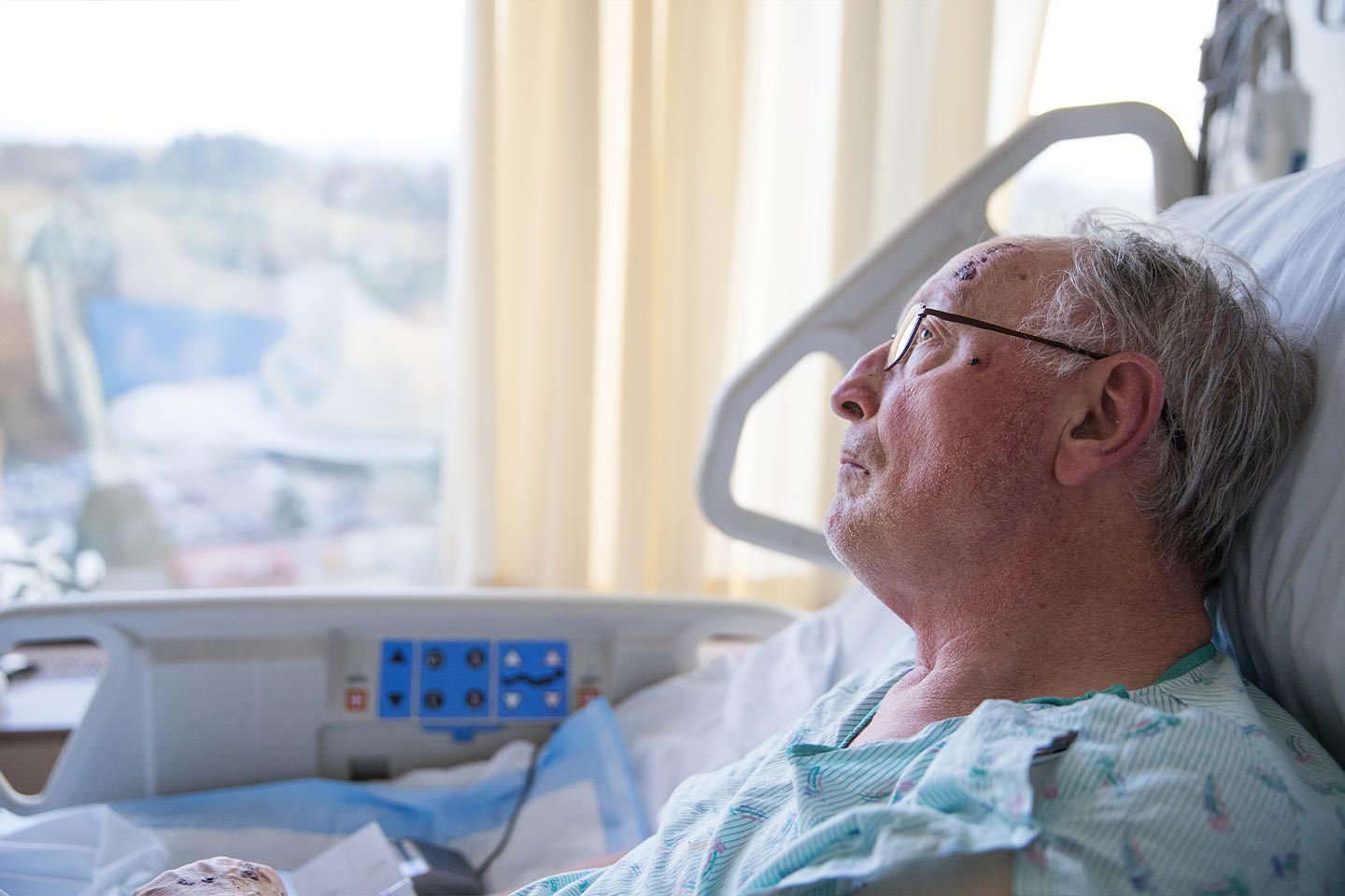 Photo of an older man in a hospital bed