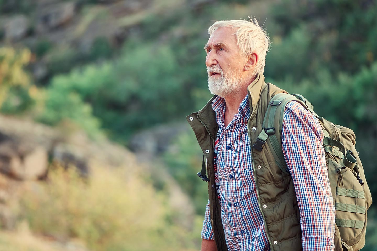 Photo of man on a hike with a khaki backpack