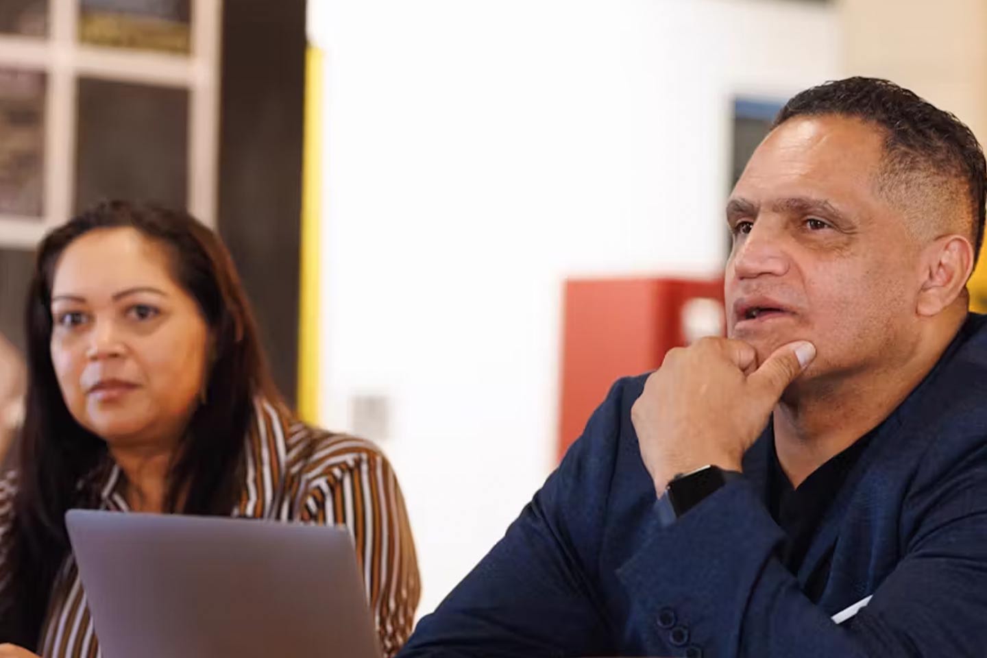 Photo of two people and a laptop