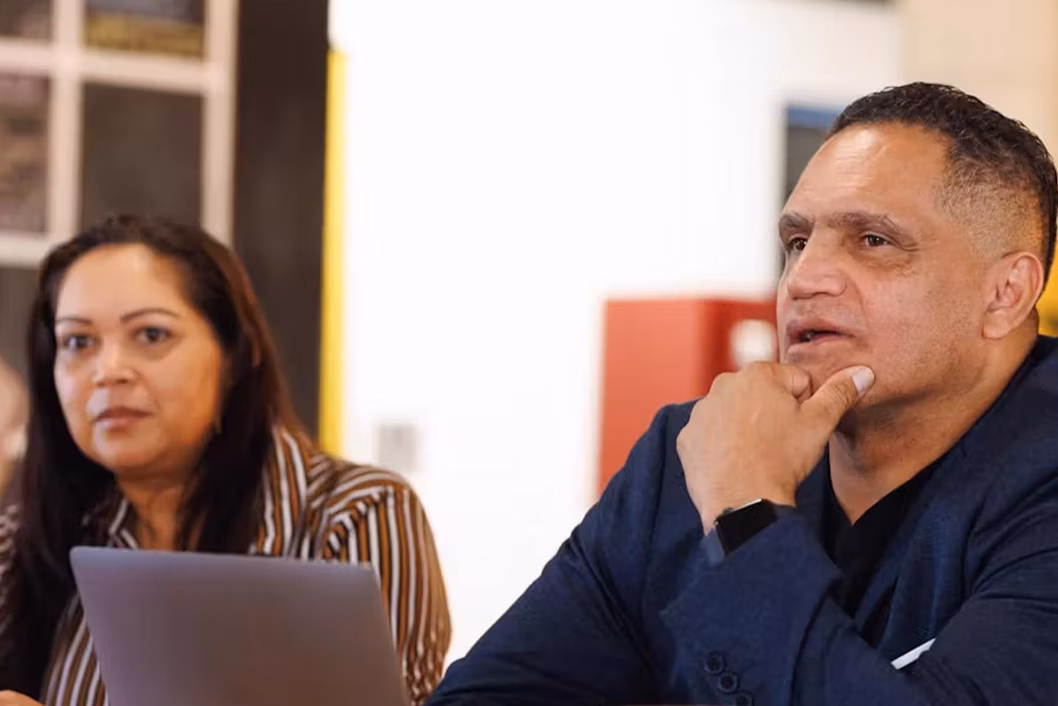 Photo of two people and a laptop
