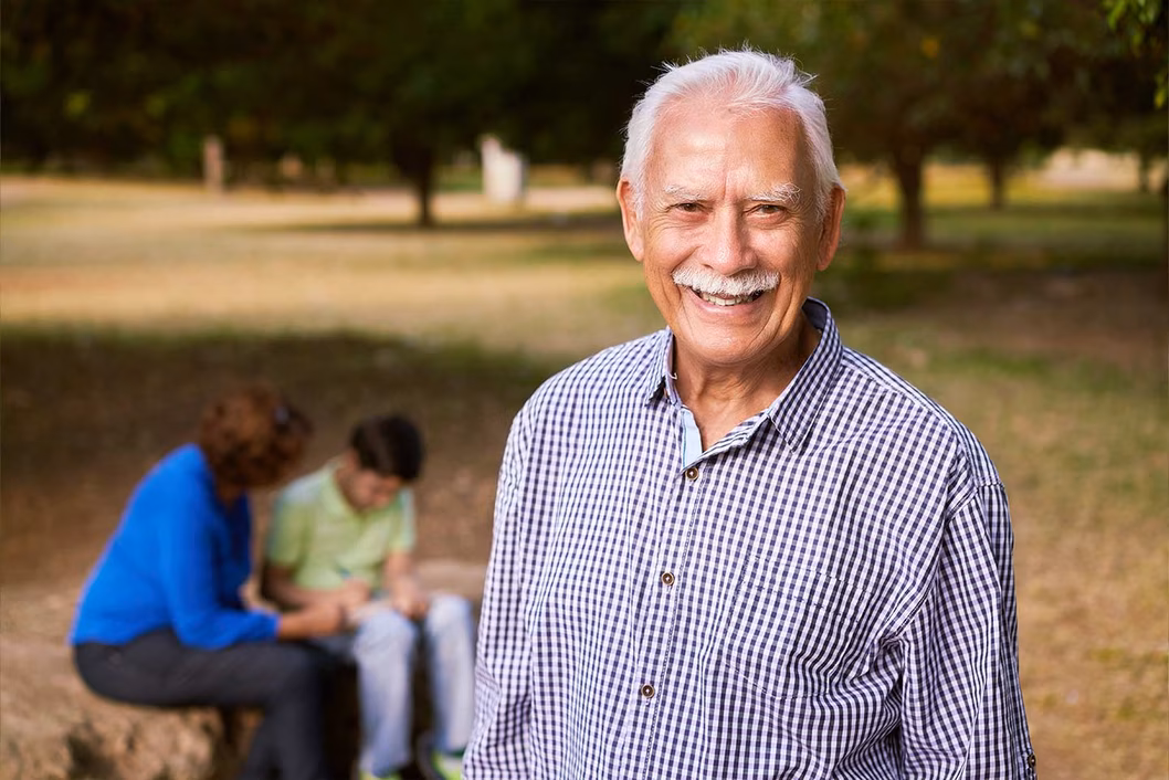 I mage of an older south east asian man in a part with his family