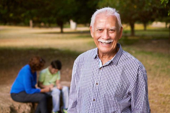 I mage of an older south east asian man in a part with his family