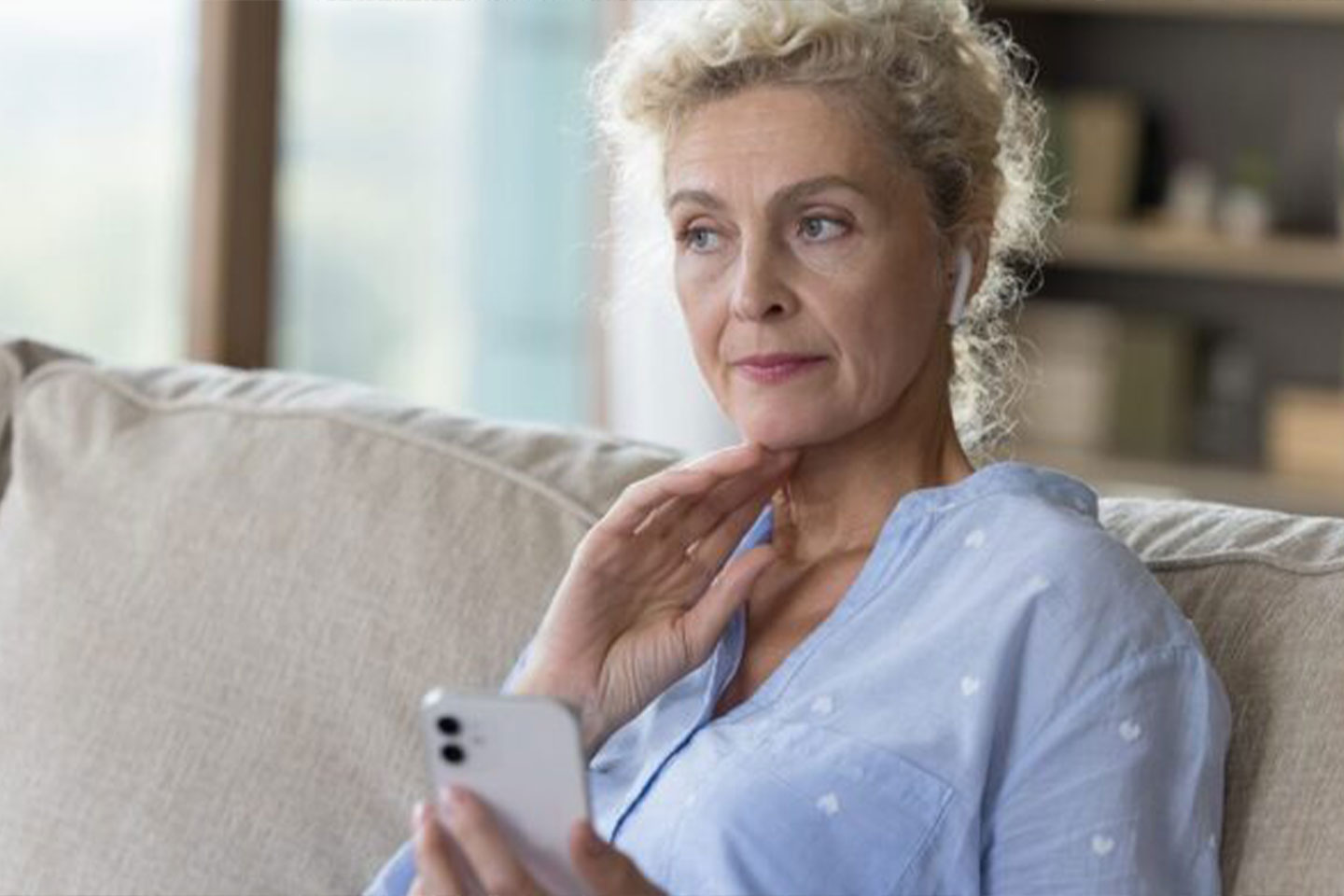 Photo of woman in a blue shirt pondering something
