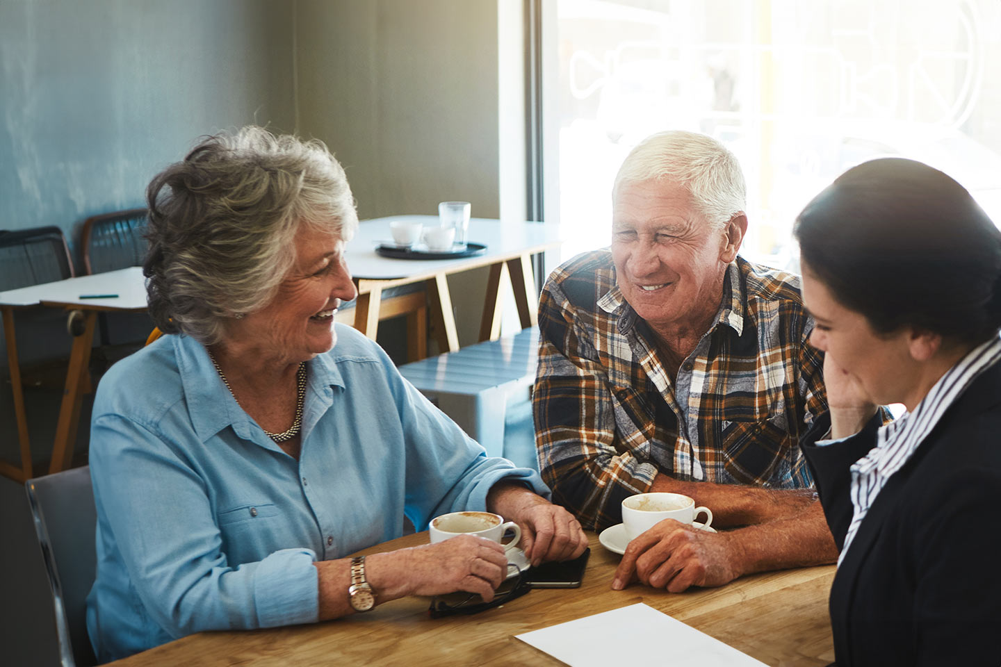 Photo of three people enjoying a cuppa together