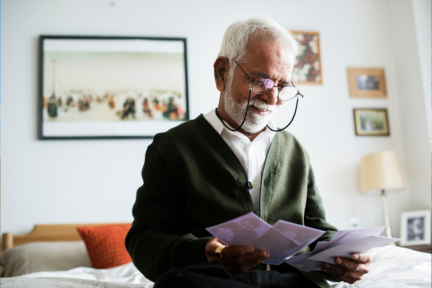 Photo of older man happily looking at photos