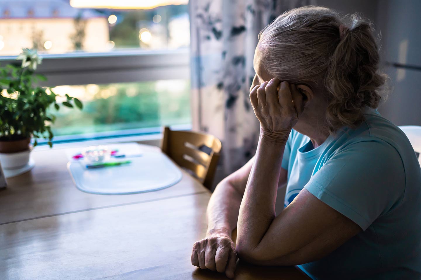 Photo of a woman with a pony tail and a sky blue t-shirt