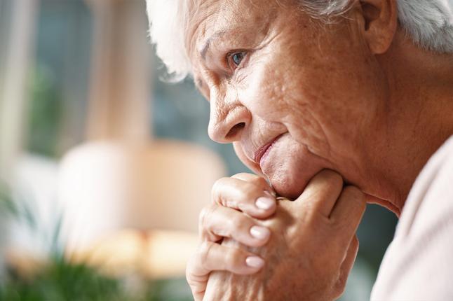 Photo of a woman resting her chin on her clasped hands