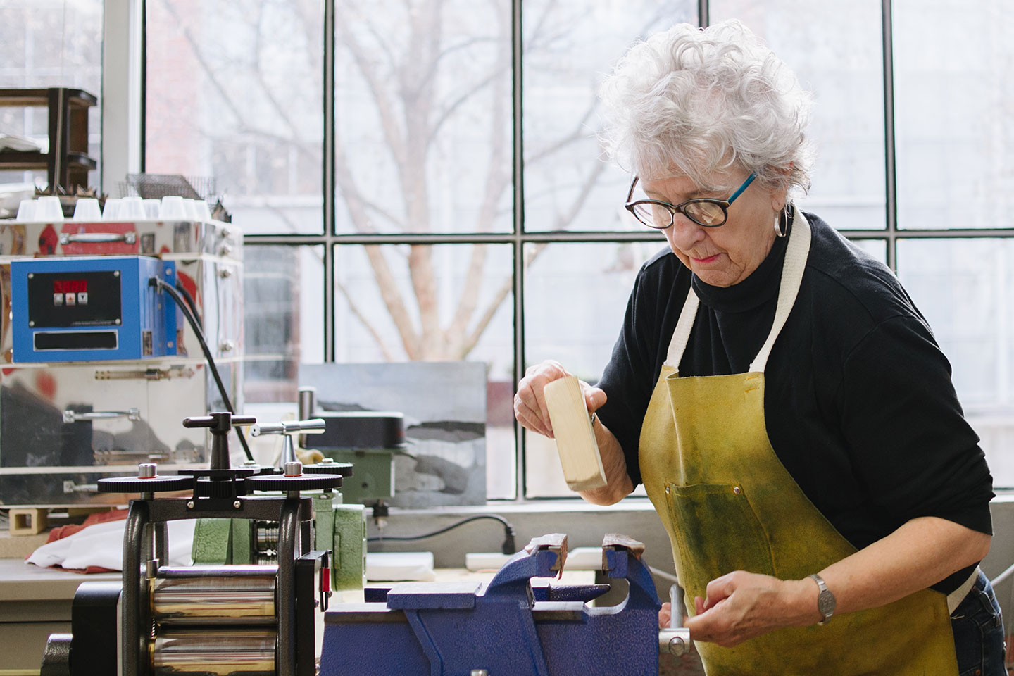 Photo of a woman in a light filled workshop